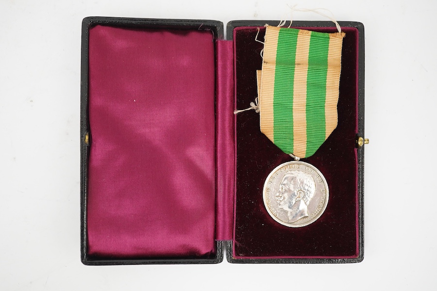 A cased Italy, Kingdom. Messina Earthquake Medal 1908, awarded to J. Stringer? (Worn), A.B. 18254 H.M.S. Bacchante, together with another uncashed example, unnamed, (2). Condition - fair.